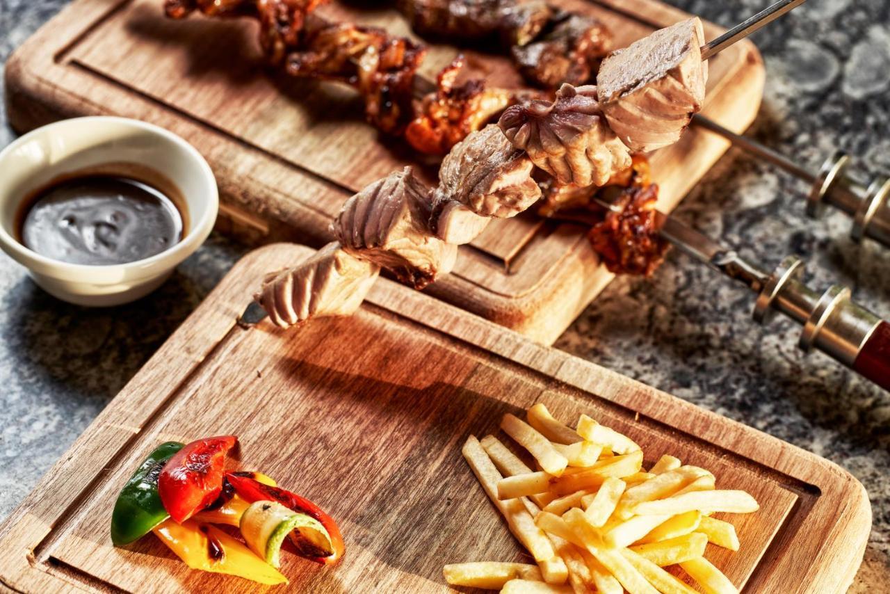 Fanar Hotel & Residences Салала Экстерьер фото A wooden cutting board